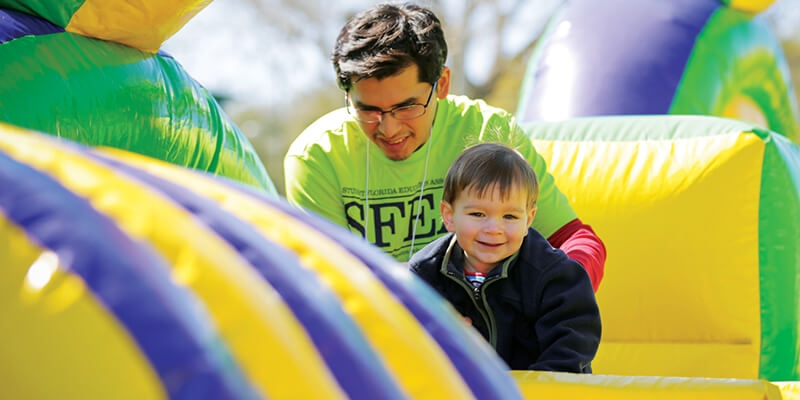 Man and child on bouncy castle